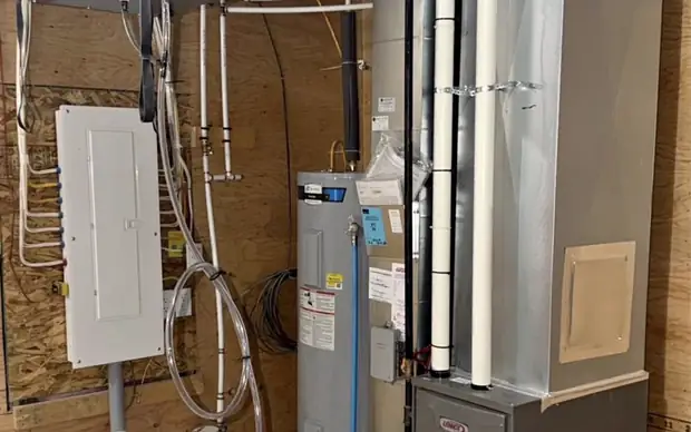 Lennox furnace, water heater and ductwork in a finished mechanical room