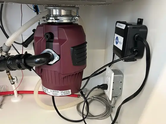 Garburator and hot water dispenser wired under a kitchen sink