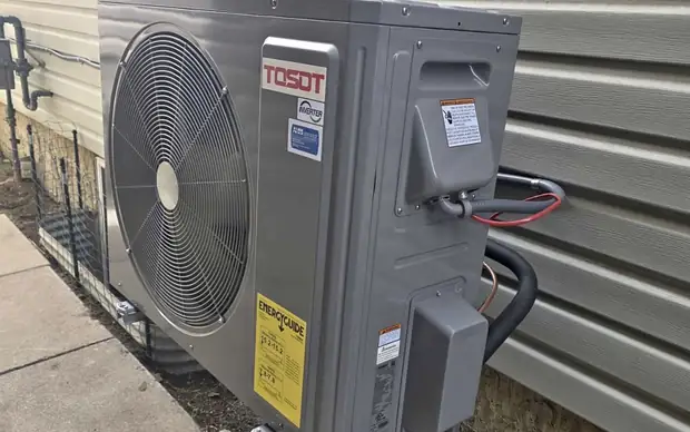 Tosot inverter heat pump mounted on a bracket outside a home